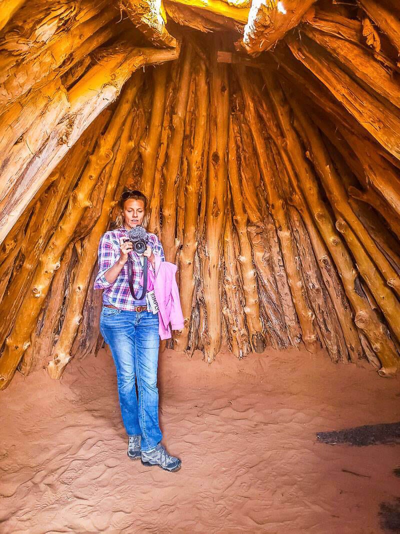 caz standing Inside a Hogan in the desert at Monument Valley