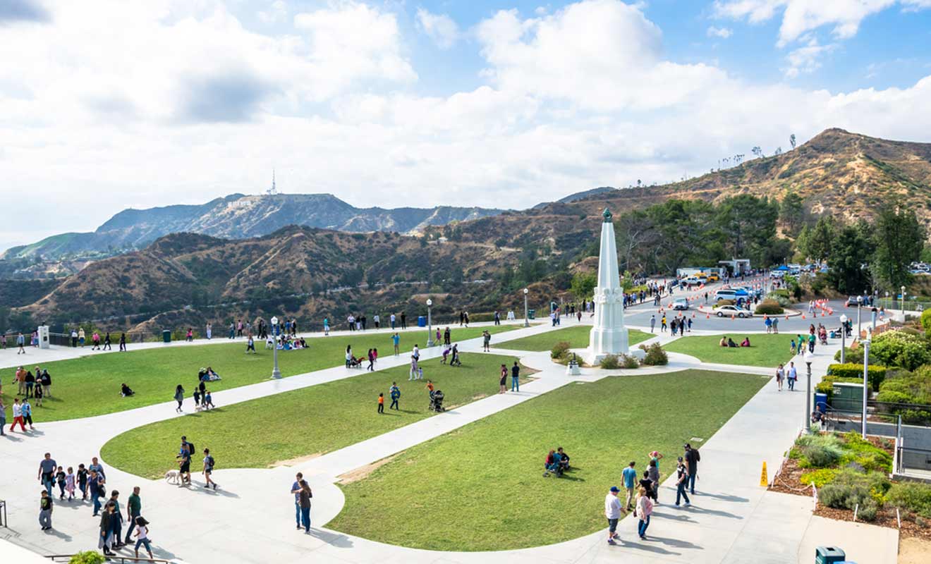 a group of people walking around a park