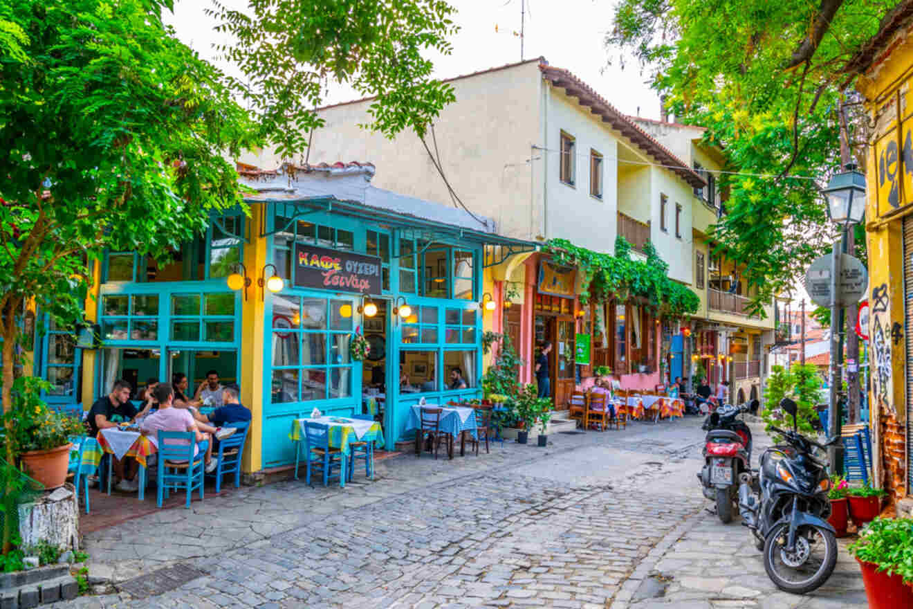 street with outside restaurants and people sitting at a table