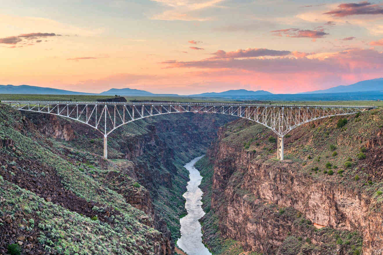 a bridge over a canyon with a river below