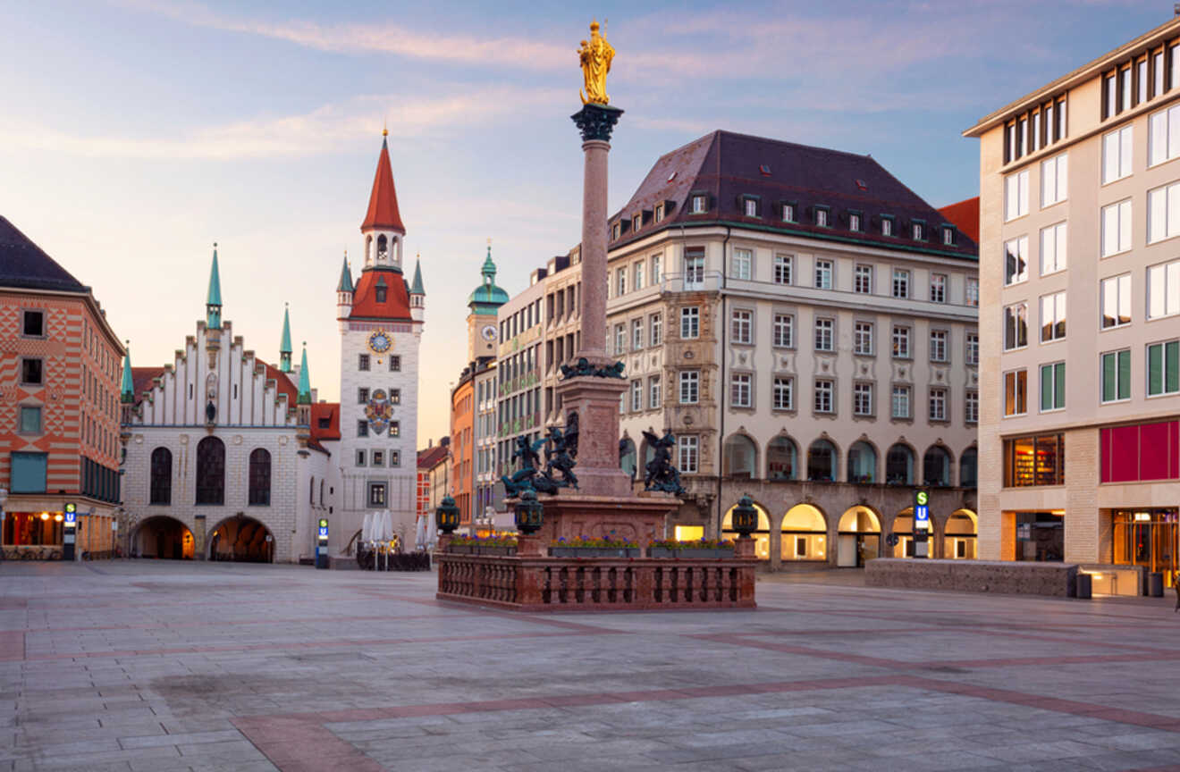 a city square with a clock tower in the background