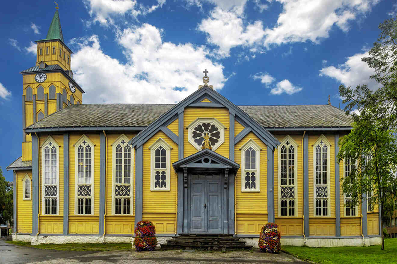 a yellow and blue church with a clock tower