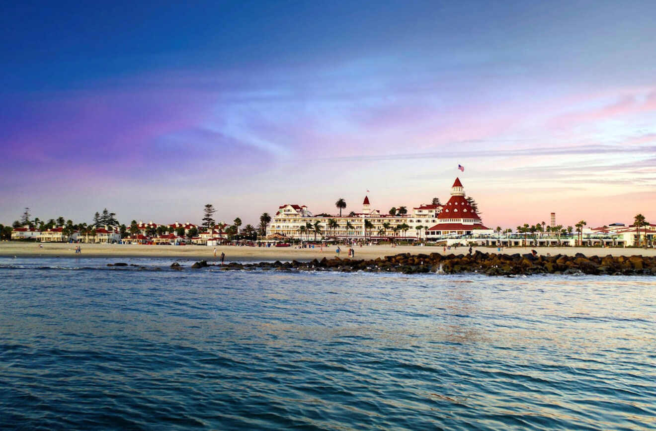 a view of a beach with a hotel in the background