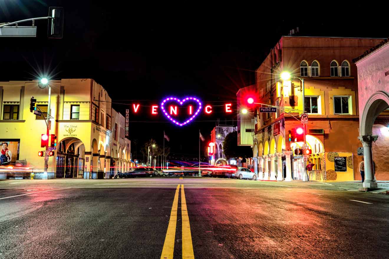 a city street at night with a neon sign