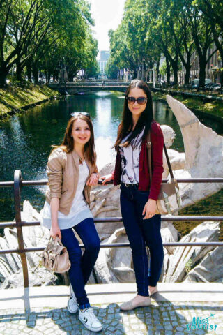 Two girls on a river bridge in Konigsallee