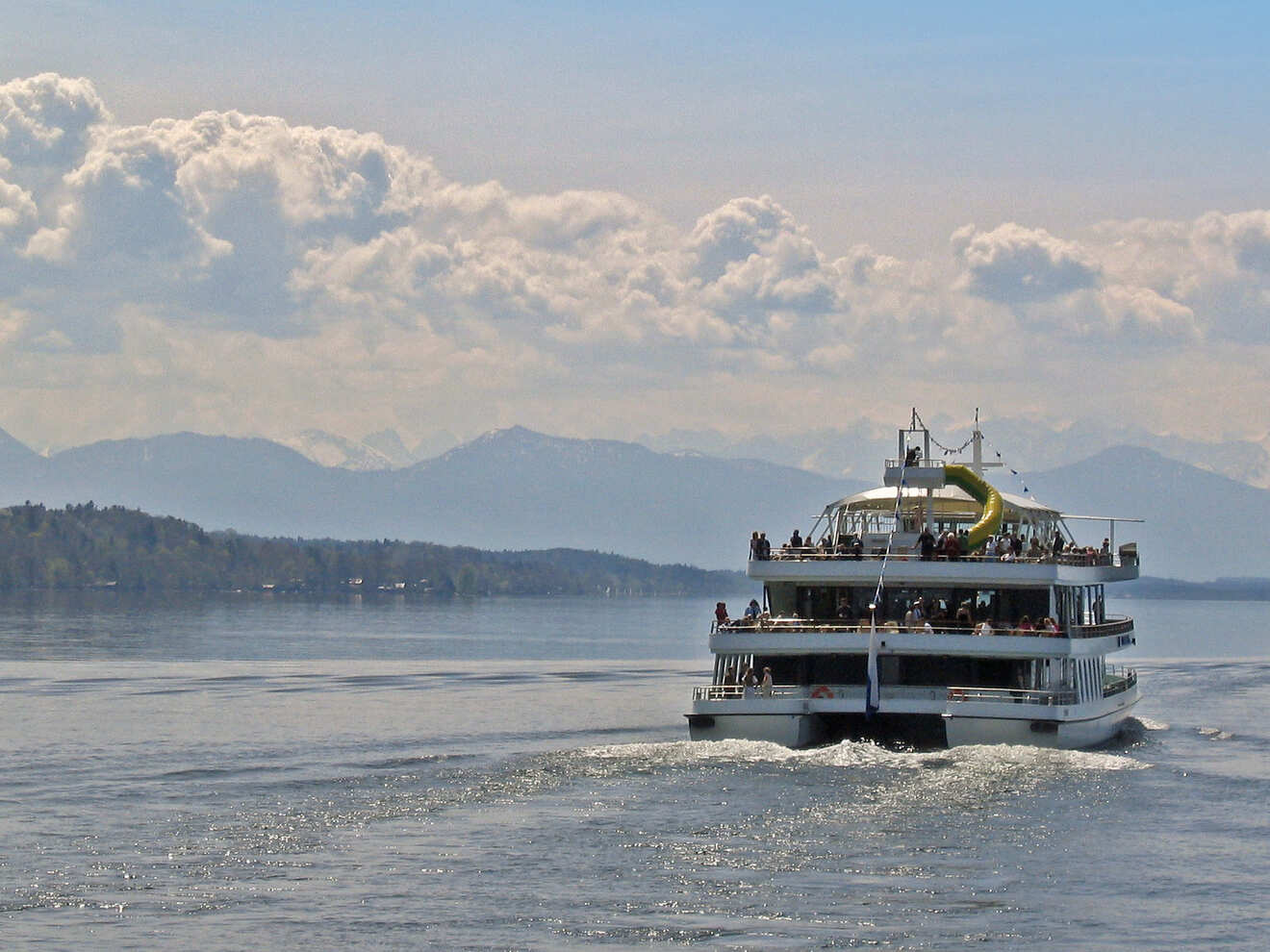 a large boat with people on it in the water