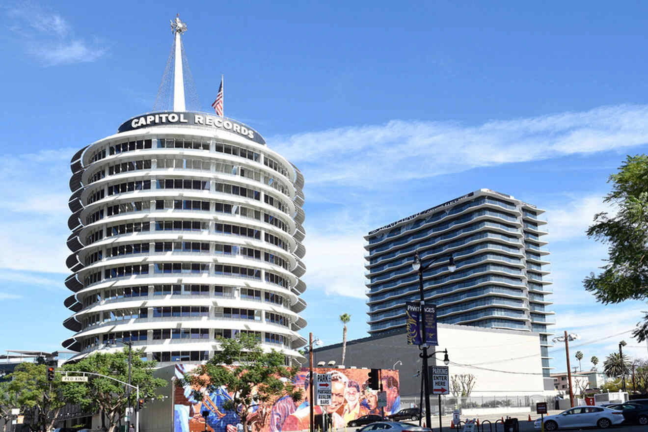 a very tall white building sitting next to a traffic light