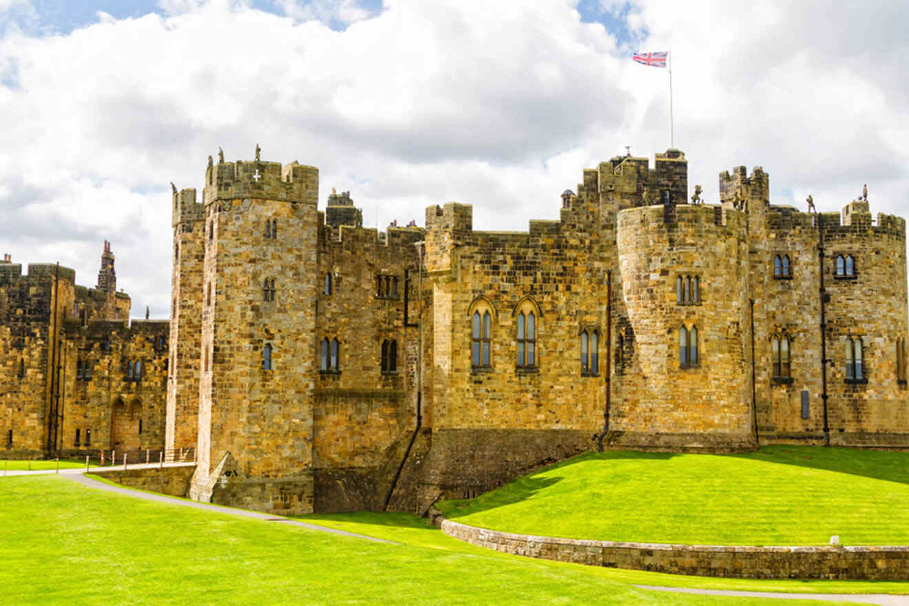 a castle with a flag on top of it surrounded by grass