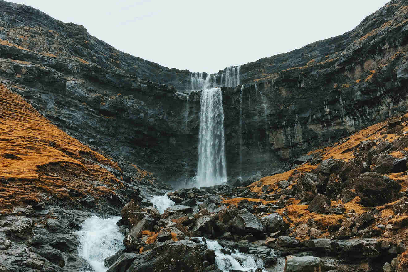 a waterfall is shown in the middle of a rocky area