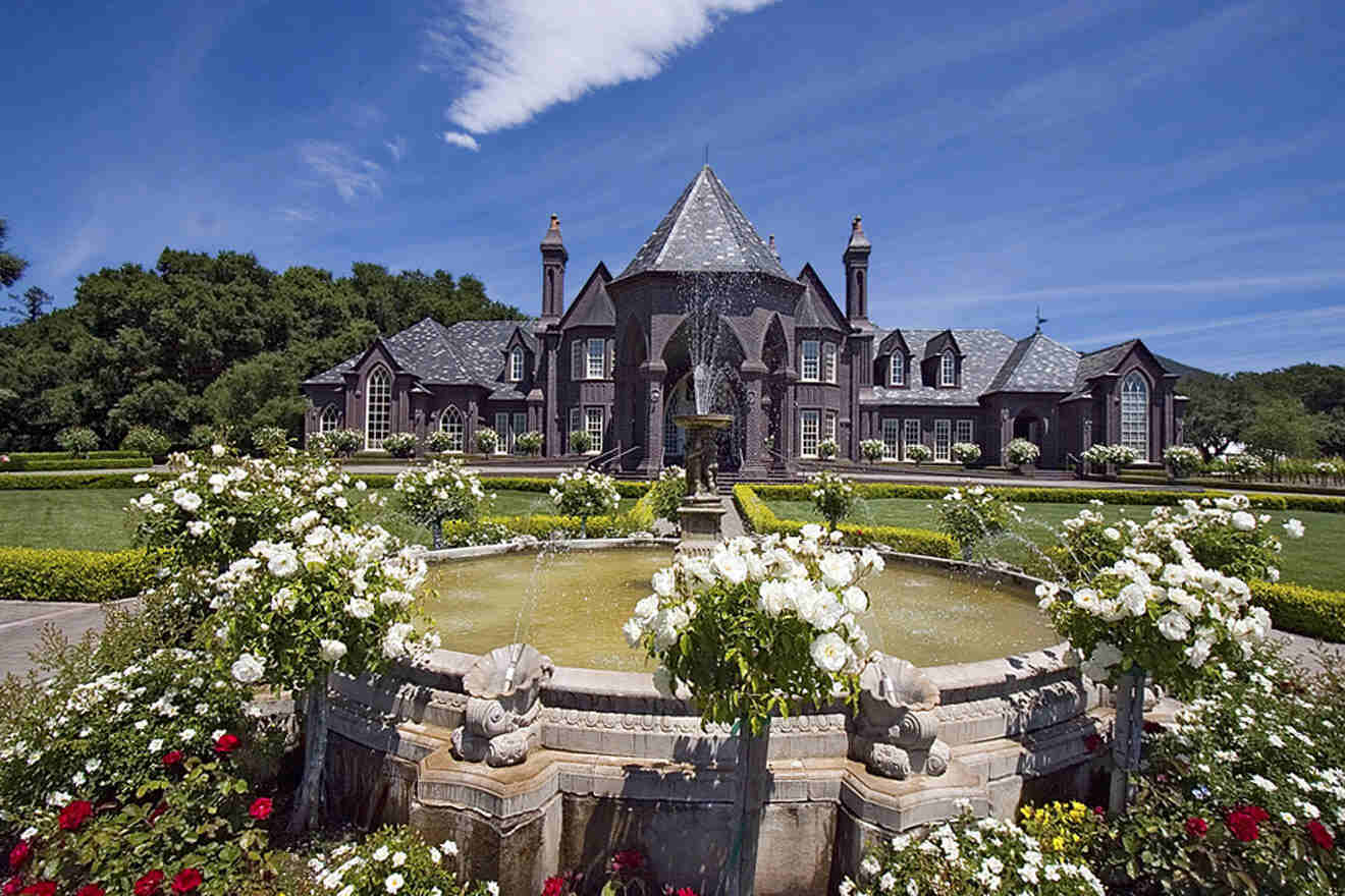 a large house with a fountain in front of it