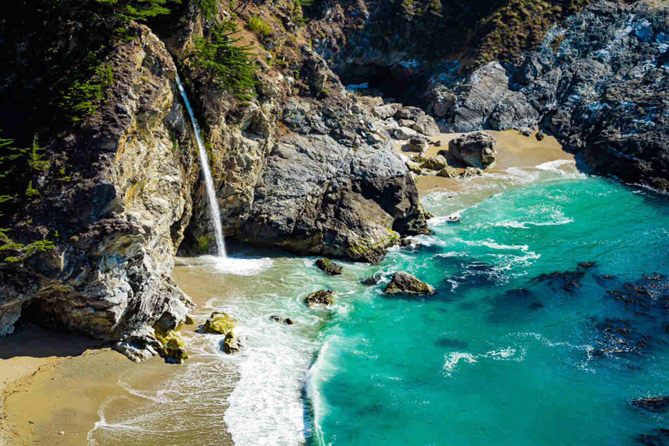 an aerial view of a beach with a waterfall