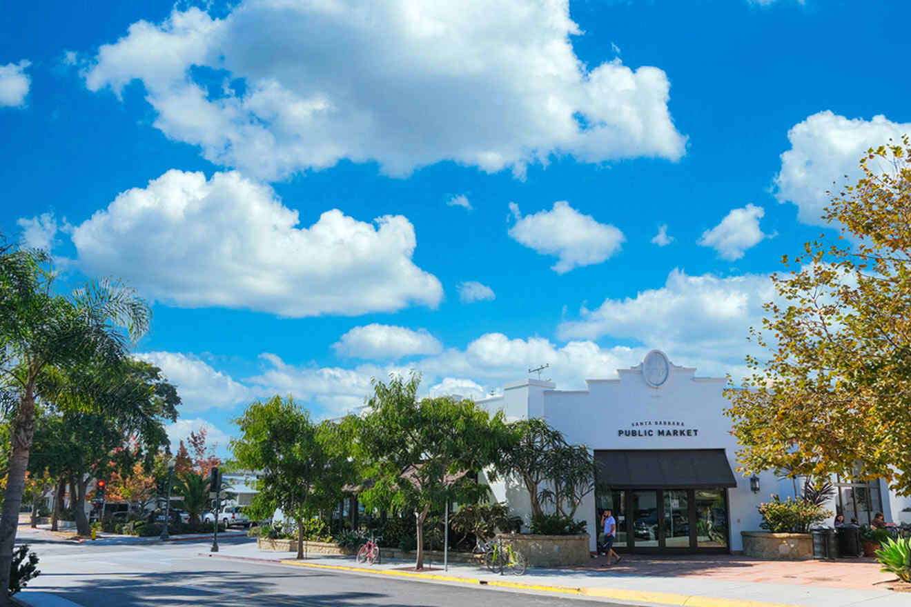 a street with a building and trees on the side of it