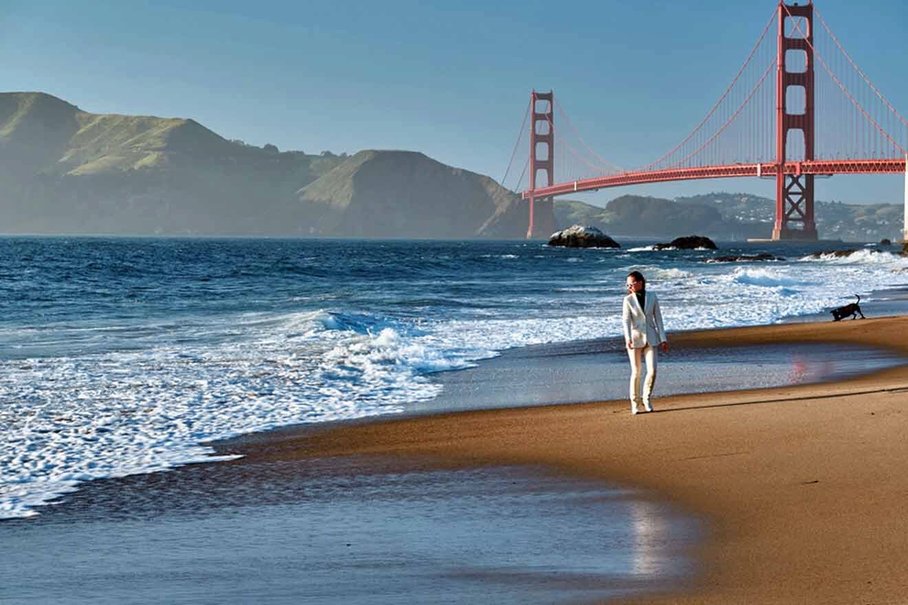 a woman standing on a beach next to the ocean