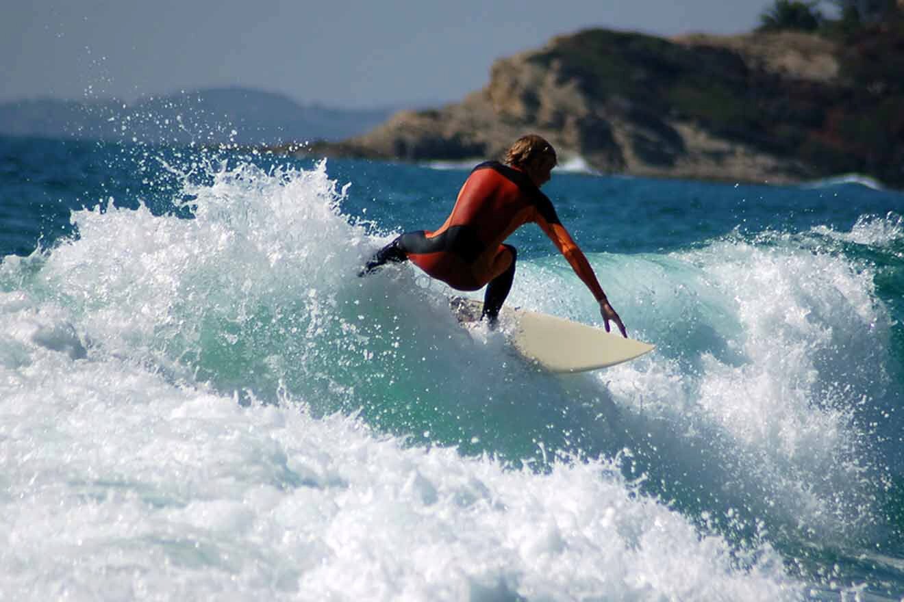 a man riding a wave on top of a surfboard