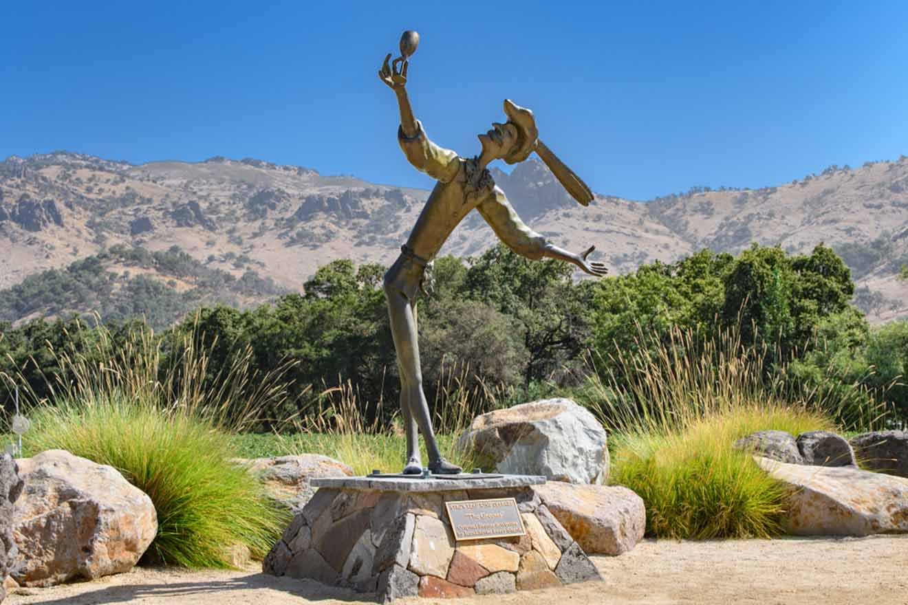 a statue of a man holding a glass of wine in his hand