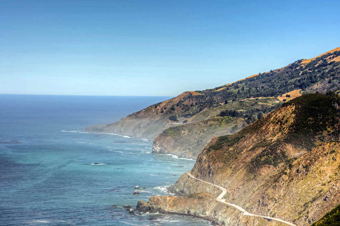 a scenic view of the ocean and mountains