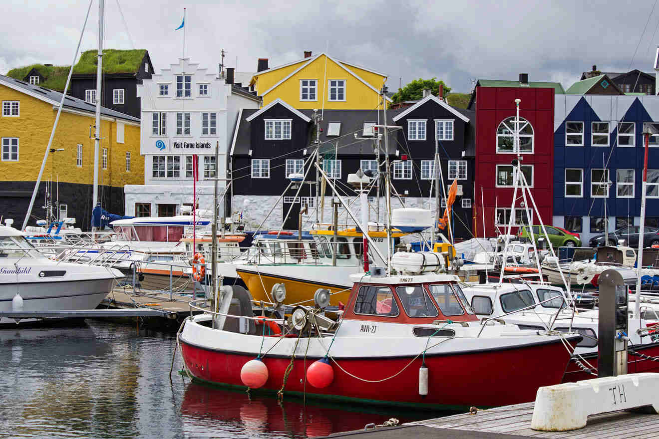 a harbor filled with lots of boats next to colorful buildings