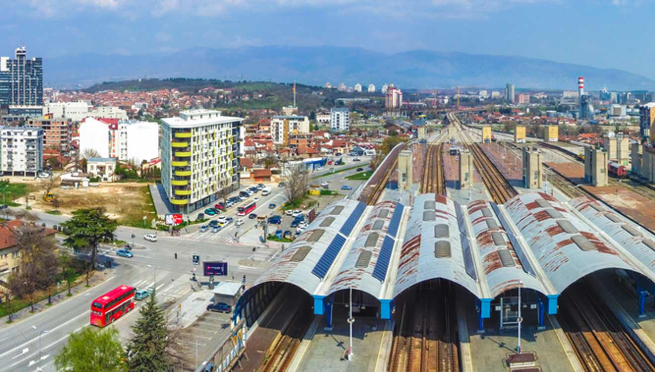 an aerial view of a train station in a city