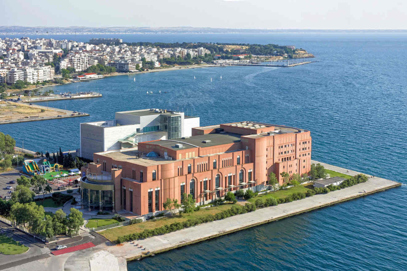 an aerial view of a building in the middle of a body of water