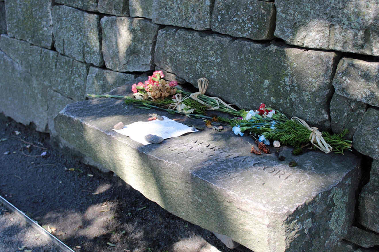 a stone bench with a bunch of flowers on it