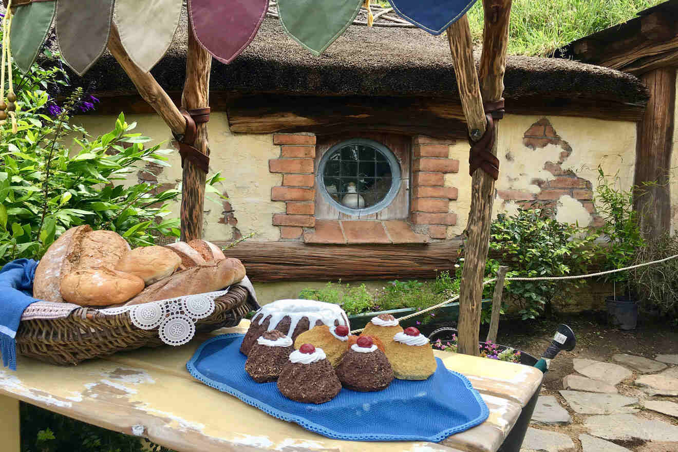 a table topped with bread and buns on top of a blue towel