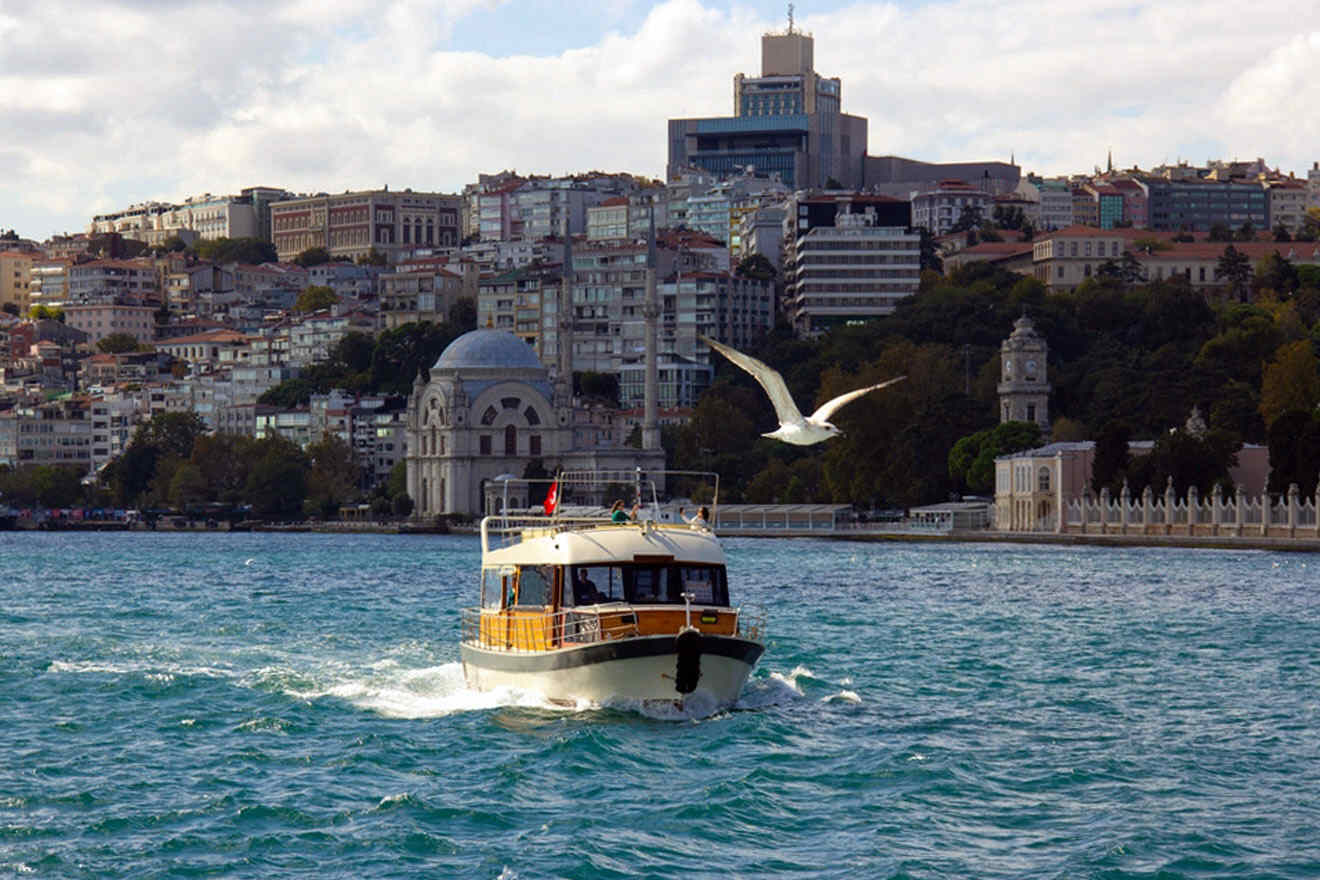 a boat in a body of water with a city in the background