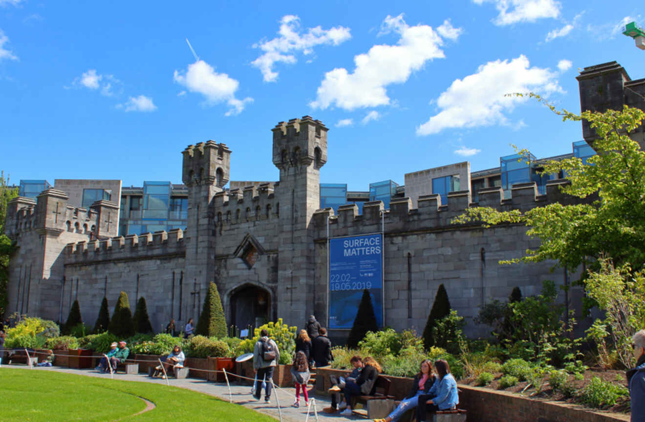 a group of people sitting on a bench in front of a castle