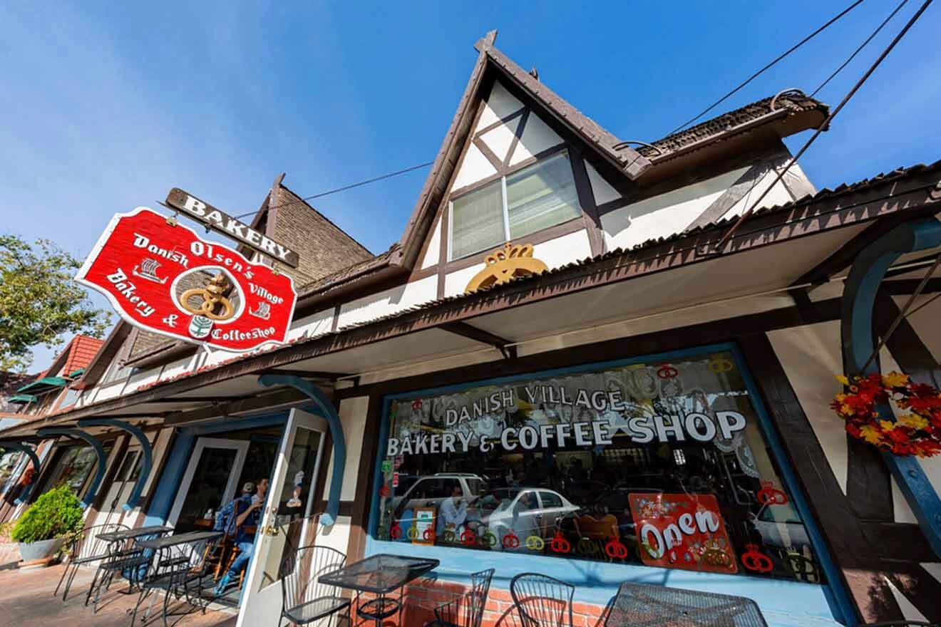 a bakery and coffee shop with tables and chairs in front of it and red sign