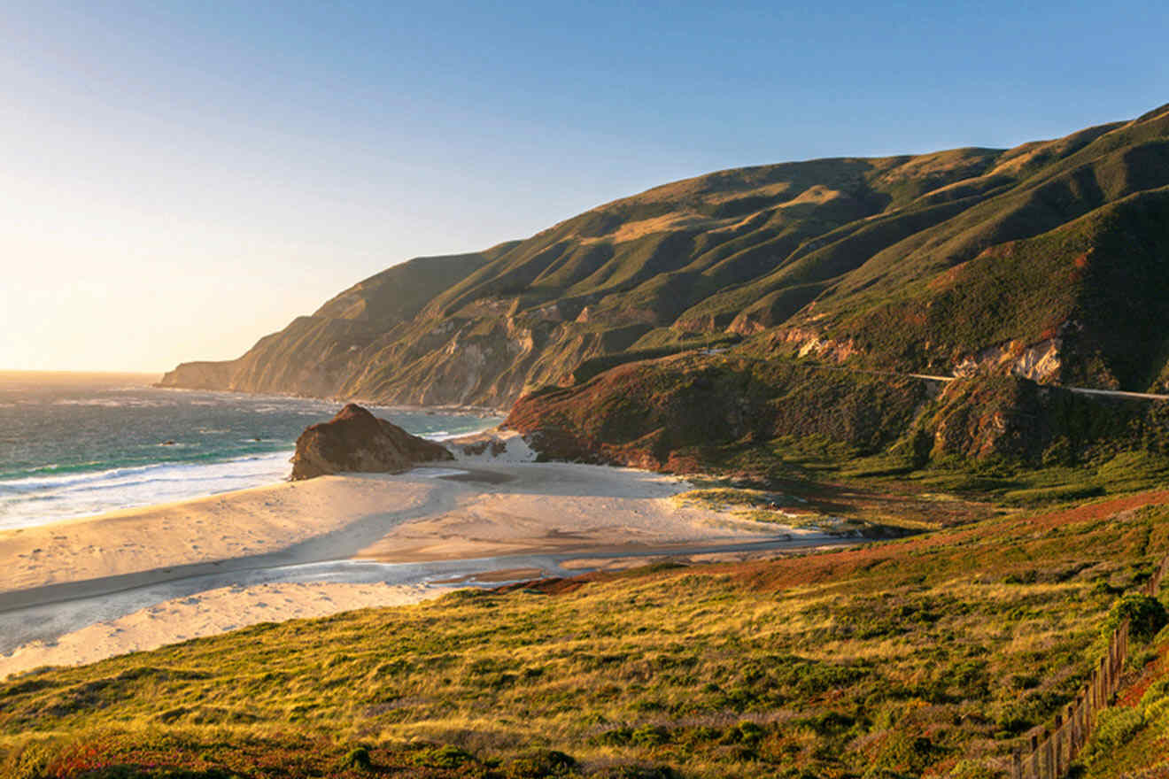 a scenic view of a beach with a mountain in the background