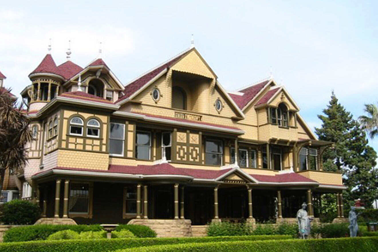 a large yellow house with a red roof