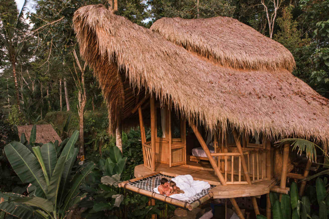 A couple hugging on a hammock in a bamboo house