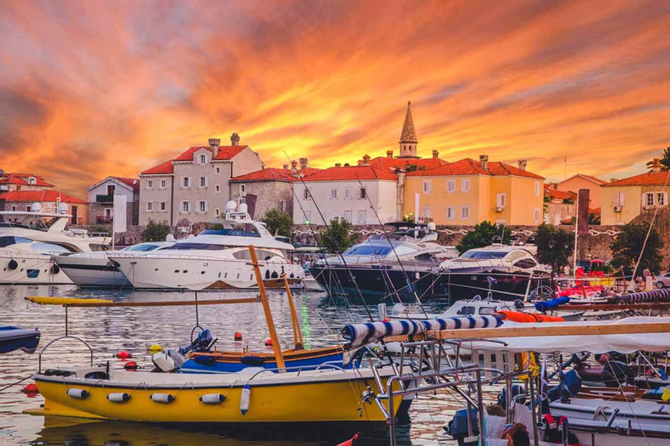 a harbor filled with lots of boats under a colorful sky