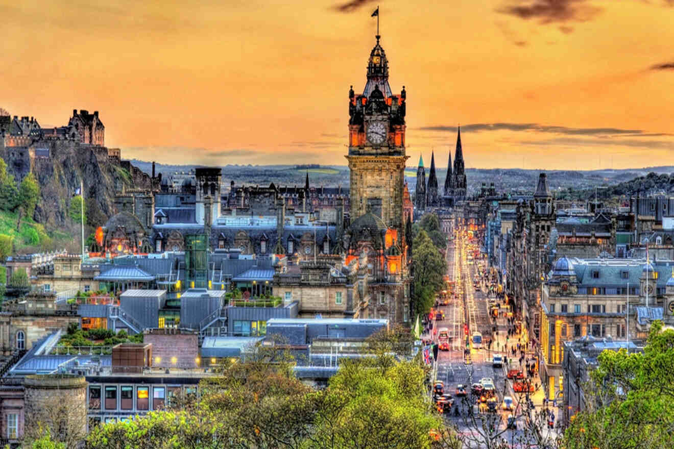 a large clock tower towering over a city at sunset