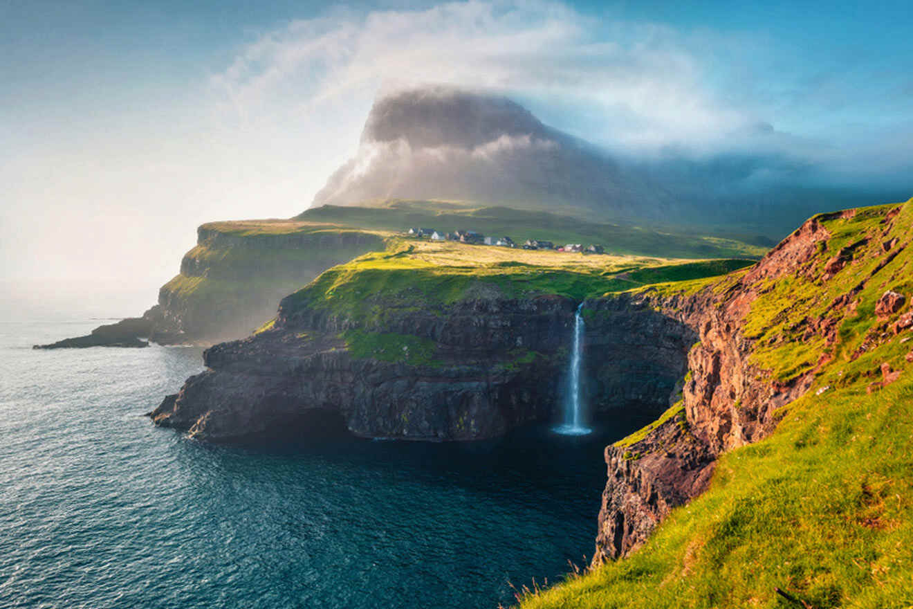 waterfall cascades from a steep cliff into the ocean