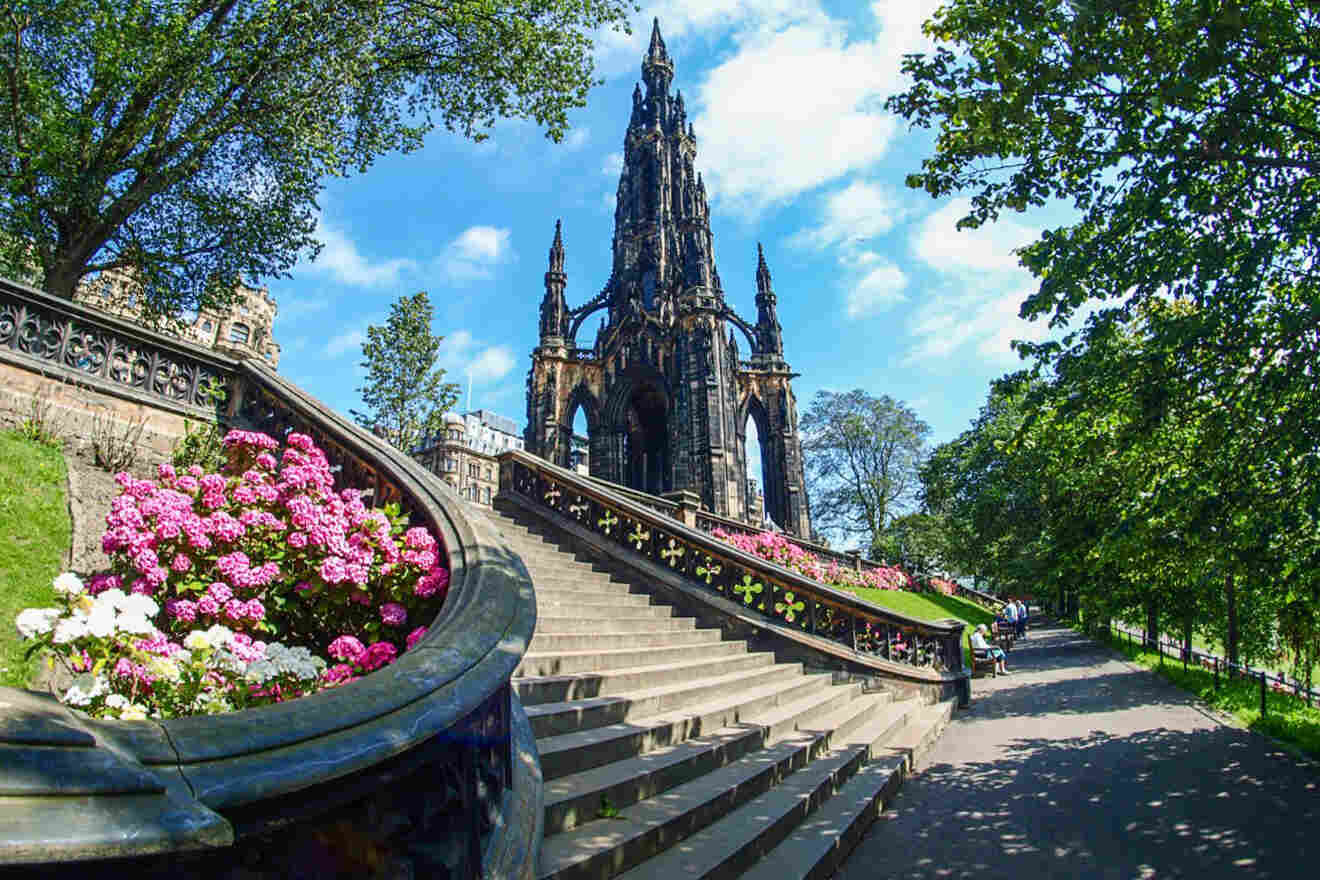 a large building with a steeple next to a bunch of flowers