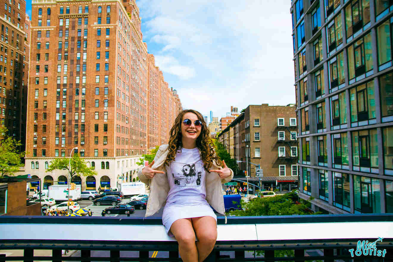 Girl sat on a bridge over a NYC bridge