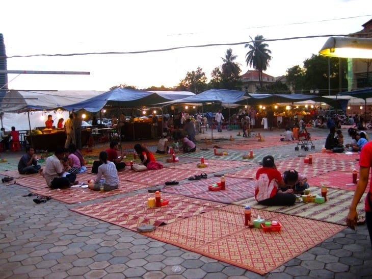 people sitting on mats