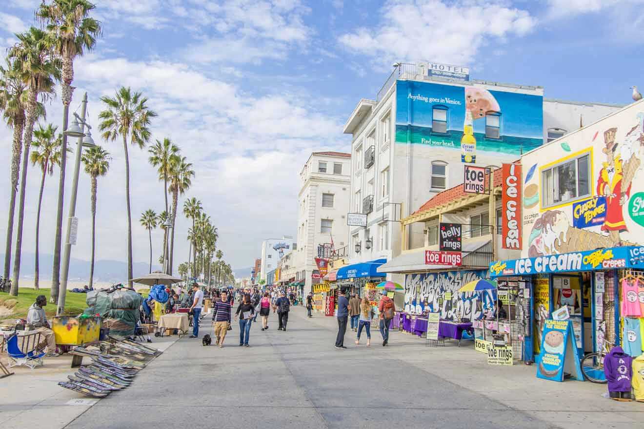 a group of people walking down a street next to shops and buildings