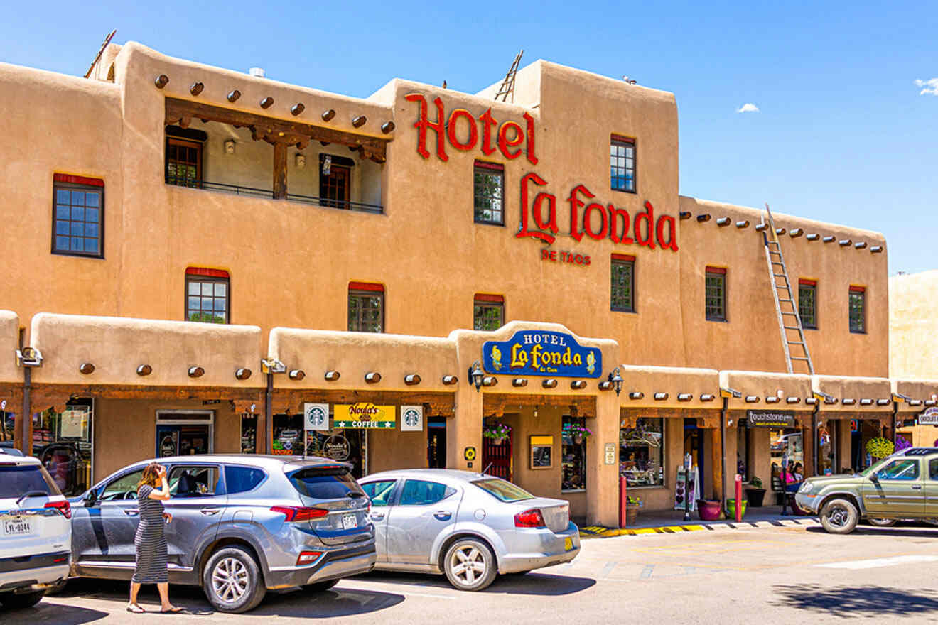 a hotel with cars parked in front of it