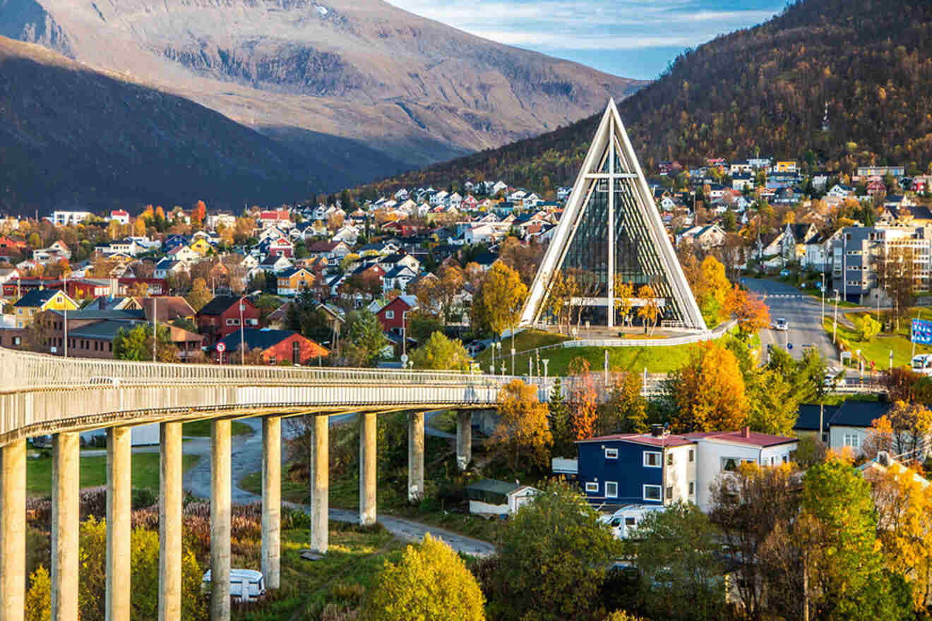 a view of a city with a bridge and mountains in the background