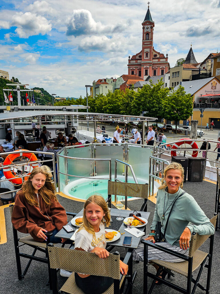 Mom and two daughters having lunch on a cruise ship