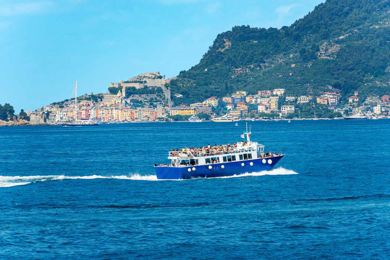 a blue and white boat in the middle of a body of water