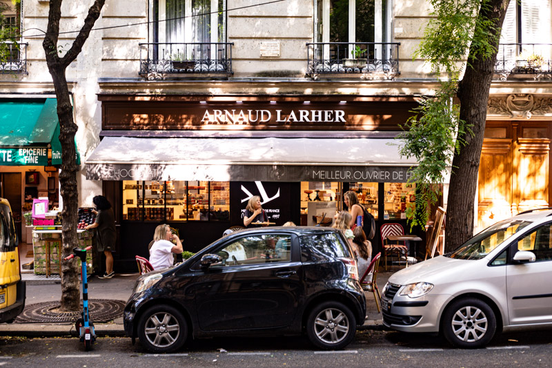 cars and people outside arnaud Larher in montmartre