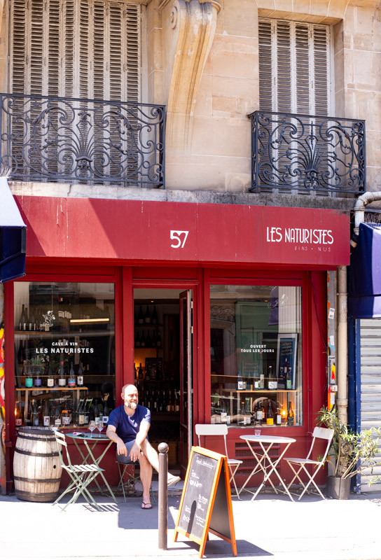 man sitting outside les naturistes