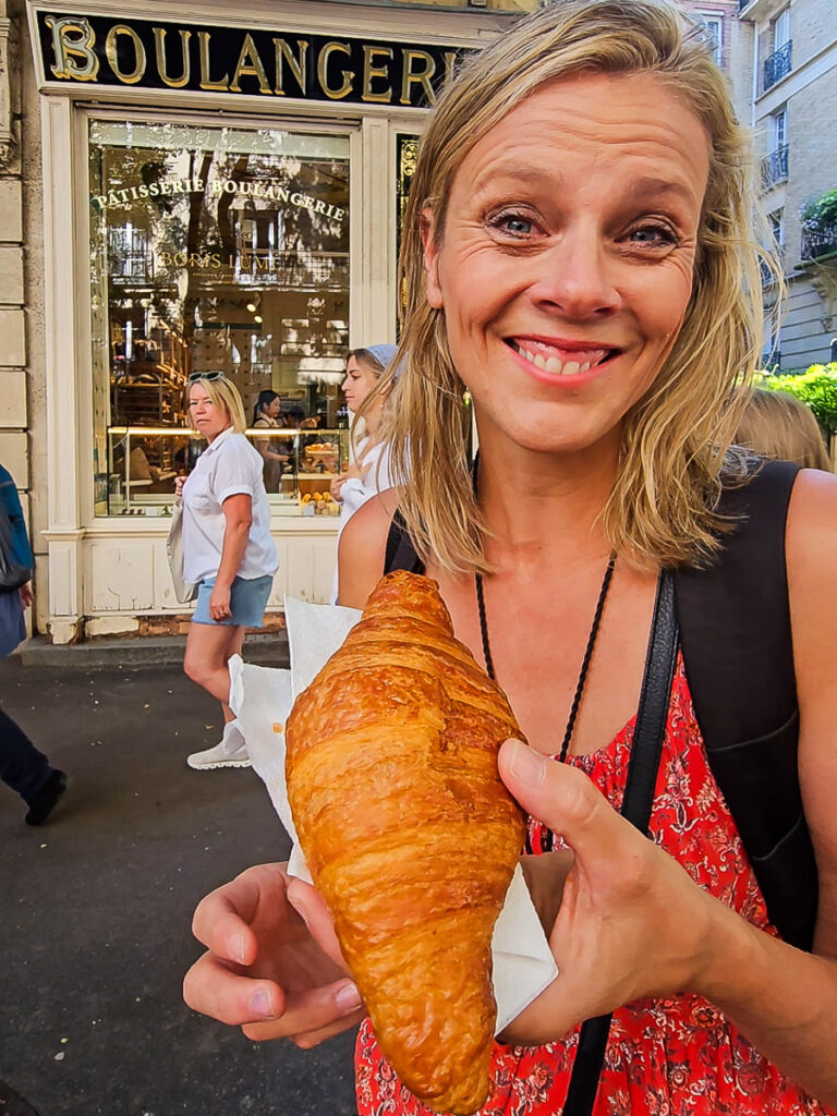 Lady eating croissants in Paris