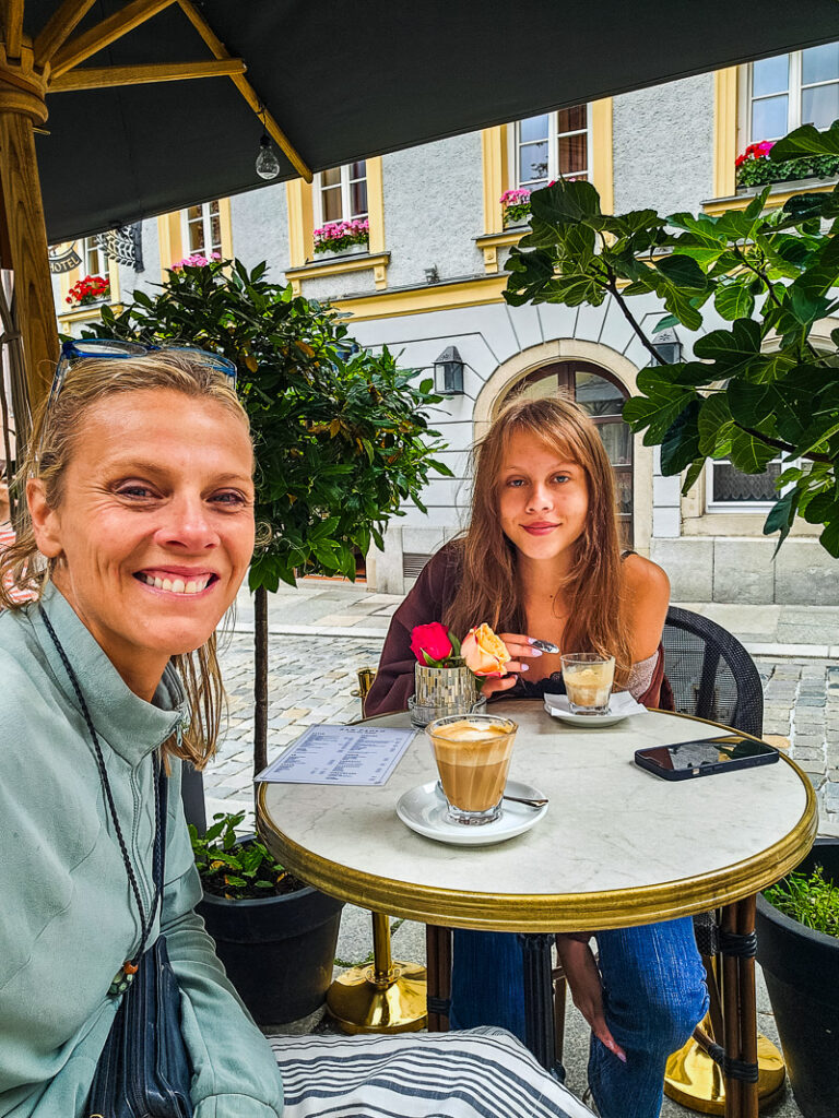 Mon and daughter having coffee in a cafe