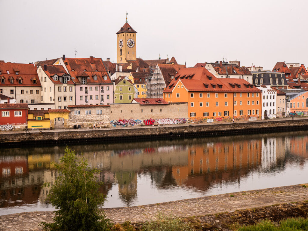 Reflections of buildings in a river in Regensburg, Germany