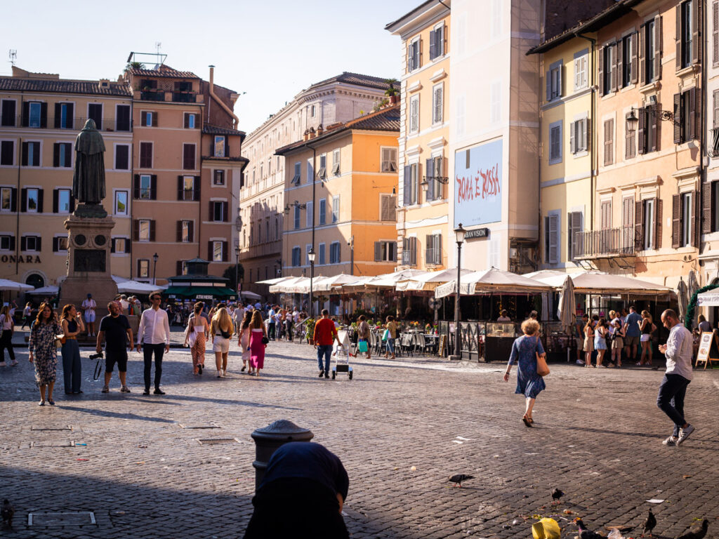 people walking through campo di fiori in rome