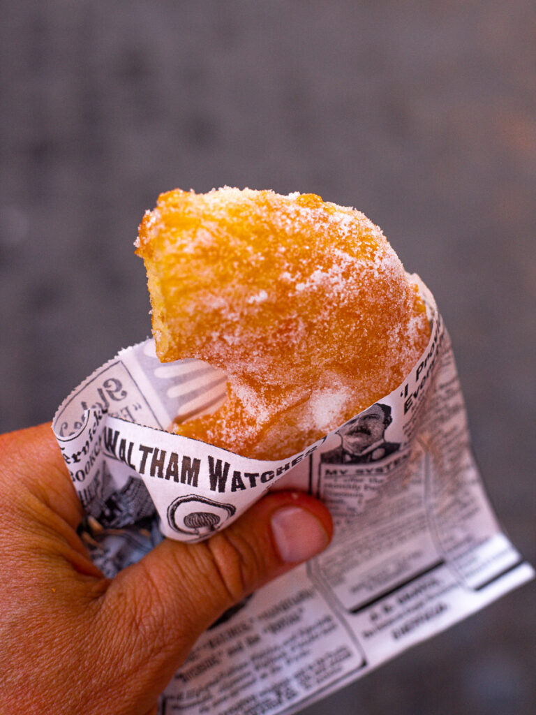 person holding italian donut