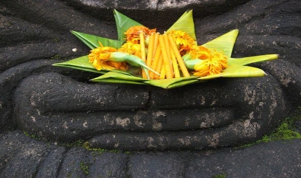 stone buddha holding lotus flower